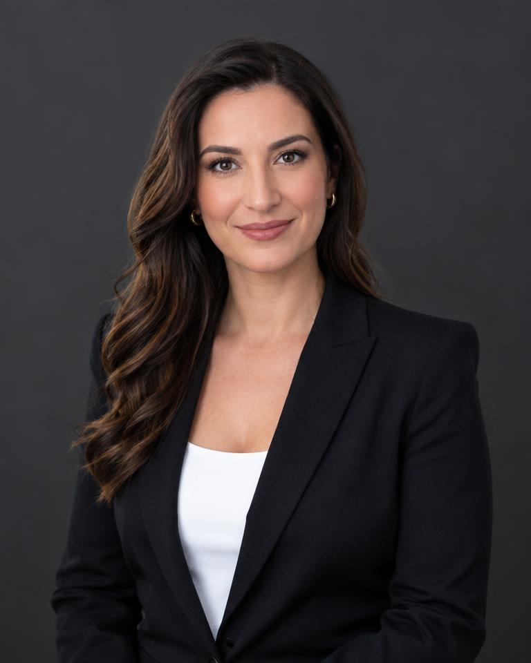 Professional headshot of a businesswoman on a dark backdrop